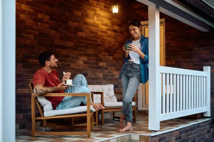 Couple relaxing on the porch of their new home